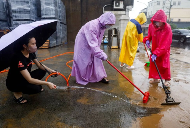 Heavy rain pounds western Japan as 2 tropical storms approach 